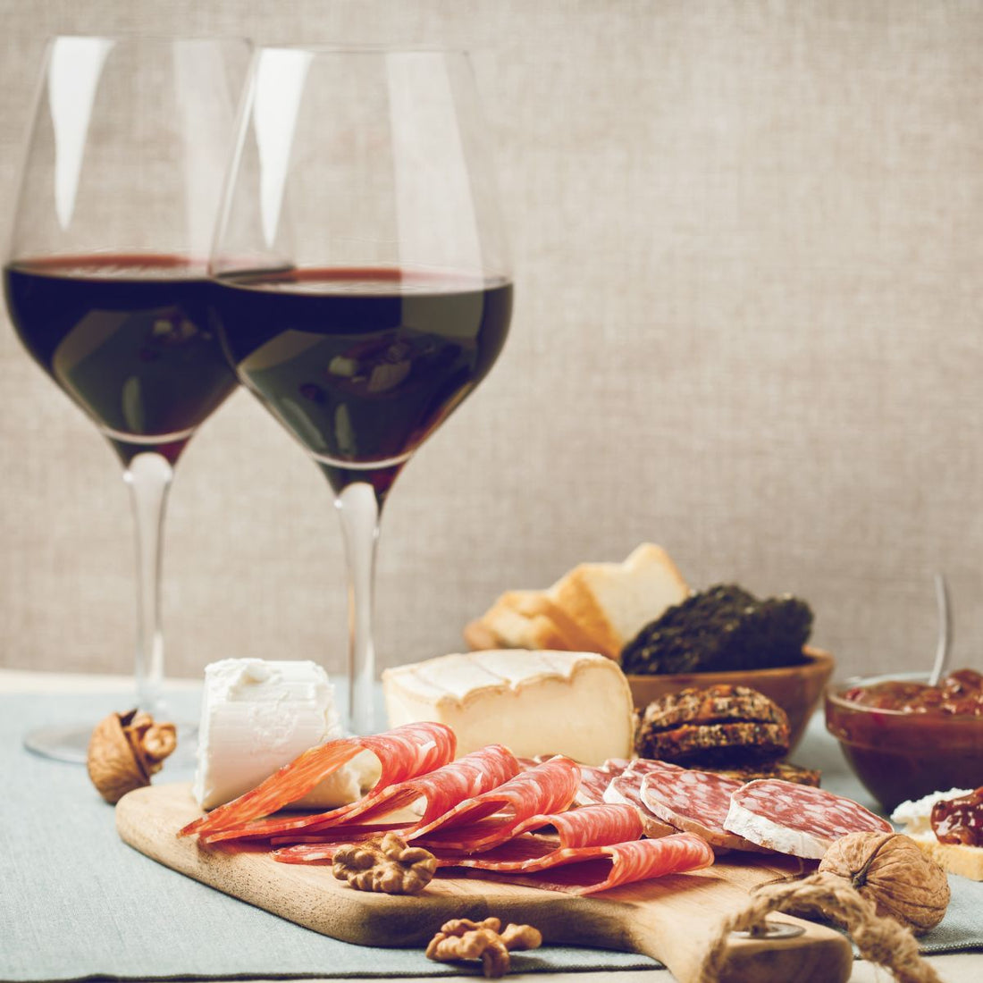 two glasses of wine and a charcuterie board for 2