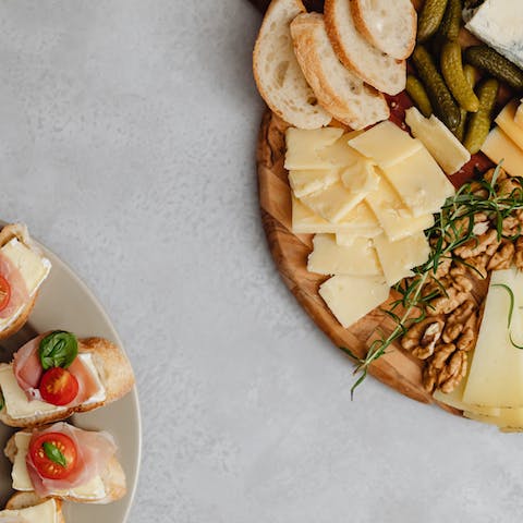 An Assorted Foods on a Charcuterie Board and a Ceramic Plate